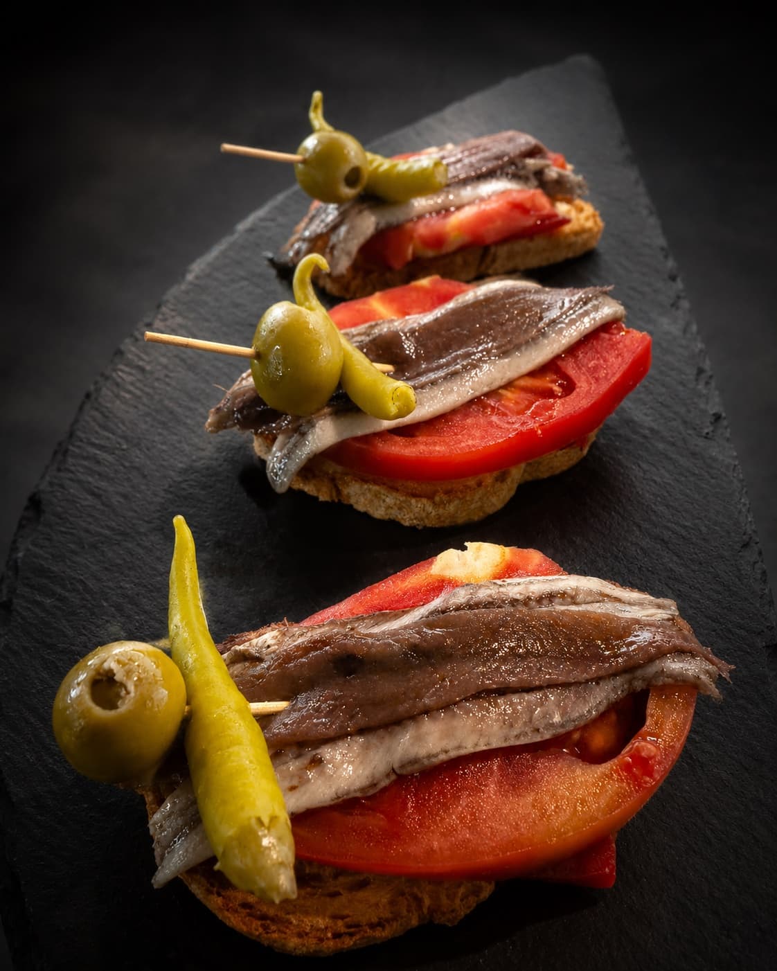 Matrimonio tostada de anchoa con boquerón, tomate, piparra y pimiento